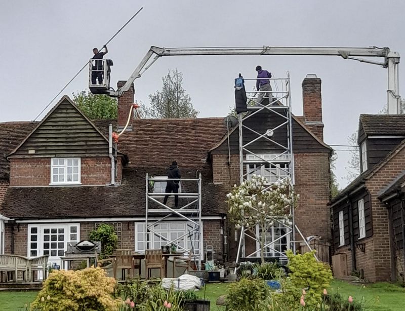 The Roof Moss Cleaners using cherry picker and scaffolding to clean roof safely and professionally in Sawtry, Cambridgeshire